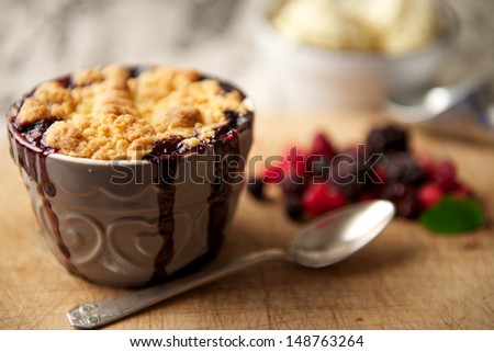 Mixed Berry Crumble Dessert with Ice-Cream in the Background