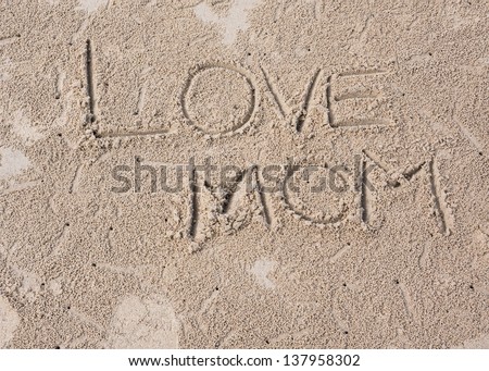 The picture of LOVE MOM wording on sand texture