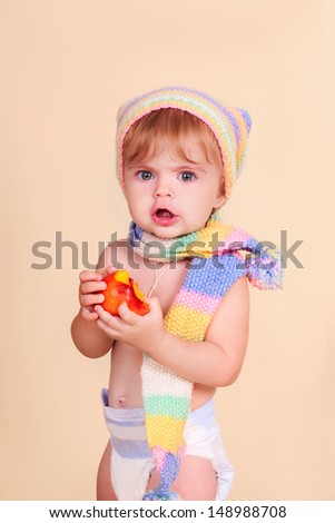 funny lovely baby girl little child in trendy in a knitted suit. happy kid playing game. Cute adorable child baby American girl. Beautiful expressive laughing smiling baby infant toddler