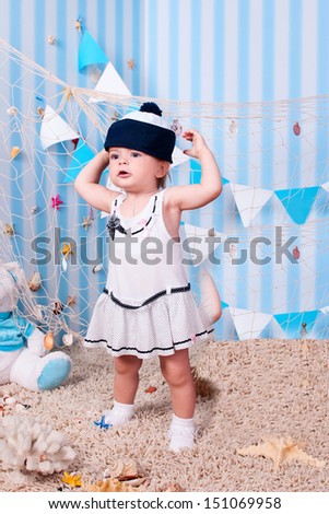 happy funny lovely baby girl little child in a suit of the seaman smiling and having fun. happy kid playing game. Cute adorable child baby American girl. expressive laughing baby infant toddler