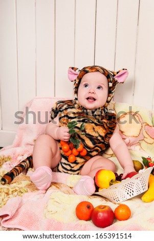 Beautiful smiling cute baby in a tiger suit happy adorable child. happy kid playing game. Cute adorable child baby American girl.