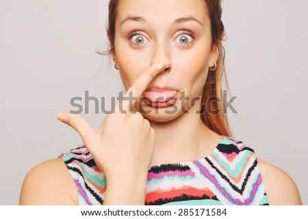 Beautiful young woman with a funny face expression.