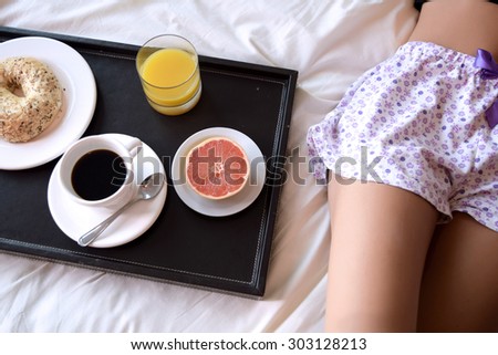 Young beautiful woman sleeping in bed, with a breakfast tray
