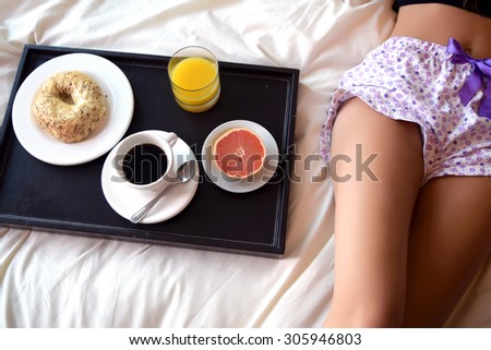 Close up of young beautiful woman sleeping in bed, with a breakfast tray