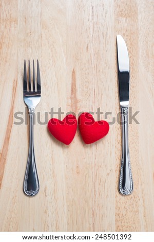 Couple Red Heart with Spoon and Fork on Wooden Table (Top View) for Valentine\'s day