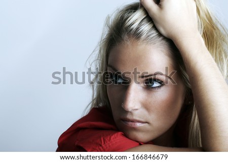 Worried beautiful young woman sitting thinking staring into space as she plans and reaches decisions