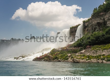Cloud over Niagara Falls - A ghost-like cloud hovering over the American and Bridal veil falls taken from a boat. Also seen are the tourists visiting the \'cave of the winds\' and quite a few sea gulls.