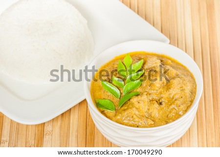 Indian Mutton Curry and Rice - Closeup view of delicious Indian mutton curry served with rice. The curry is prepared using onions, curry leaves, garlic, ginger, cayenne and black pepper.