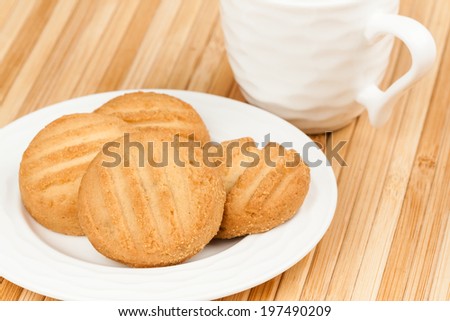 Cookies - A set of fresh, homemade cookies set on a plate with a coffee cup.