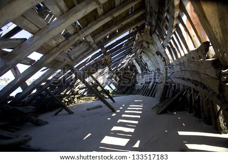 Interior of an old boat . Inside view of old fishing boat abandoned and buried in sand. Ethel, Bretagne, France
