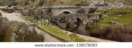 Two Stone Bridges.  Panoramic view of El Grajal Bridge and the new one over Manzanares river in Colmenar Viejo, Madrid, Spain.