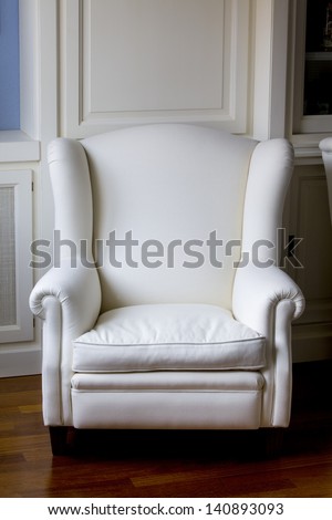 Vertical view of a white classic armchair. White Armchair.