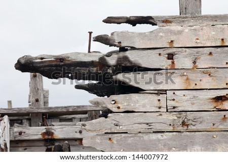 Abandoned old boat detail. Close up view of the burned planking of a ship hull.  Old boat detail.