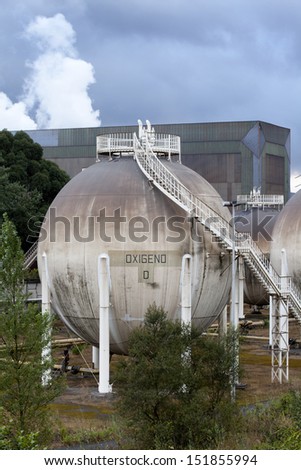 Vertical view of a big gas tank in a factory. Spherical gas tank.