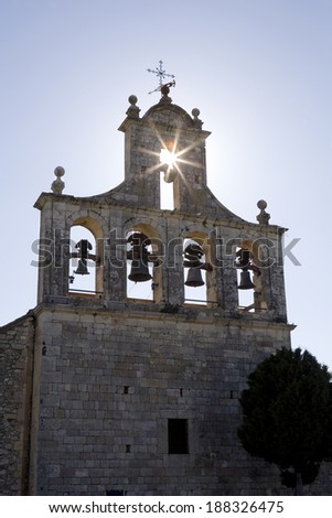 Back lighting view of the belfry of an old church in Segovia, Castilla and Leon, Spain.  Belfry