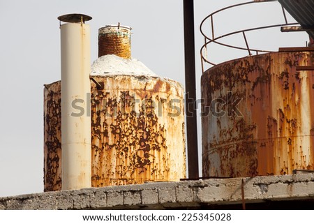 Detail of a smokestack on a white rusty old factory.  Old factory detail.