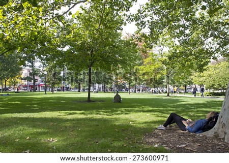 ANN ARBOR, USA - SEPTEMBER 25, 2014. Students relaxing on the meadow at Ann Arbor campus, Michigan, USA.