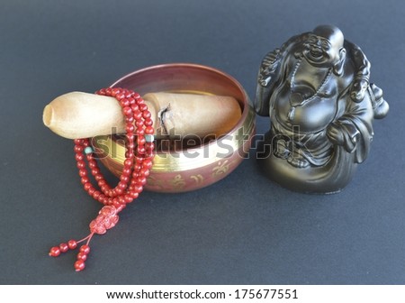 Singing Bowl with prayer beads and Buddha statue