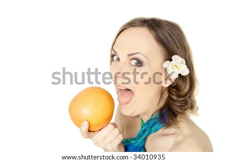 young woman biting tropical fruit