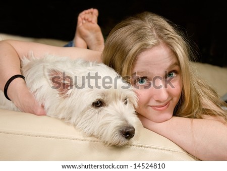 Portrait of a cute young woman enjoying quality time with her white West Highland Terrier