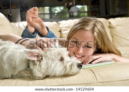 Portrait of a cute young woman enjoying quality time with her white West Highland Terrier, Jack