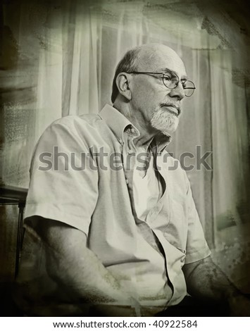 Vintage style sepia grunge portrait of a distinguished looking senior man thinking seriously about life.