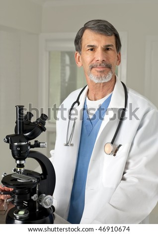 Portrait of mature doctor, scientist or chemist at the microscope.