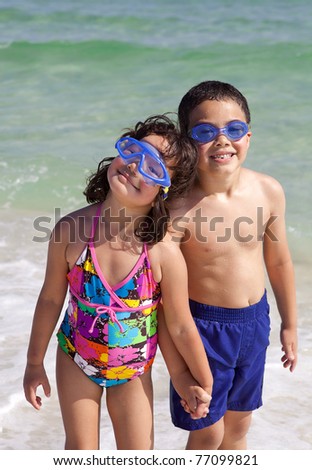 Children Holding Hands On The Beach. smiling children standing