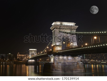 The Szechenyi Chain Bridge is a suspension bridge that spans the River Danube of Budapest, the capital of Hungary. Long exposure with full moon background