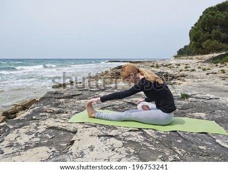 Healthy woman resting and curl up in fetal position outdoor at the sea: yoga pose. Series.