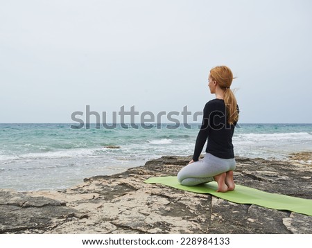 Healthy woman resting and curl up in fetal position outdoor at the sea: yoga pose. Series.