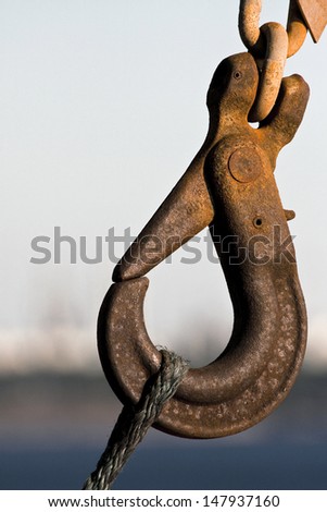 Rusty Metal Hook Attached to Worn Rope