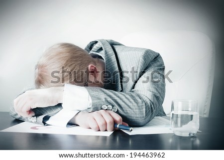 Man Sleeping on Desk at Work
