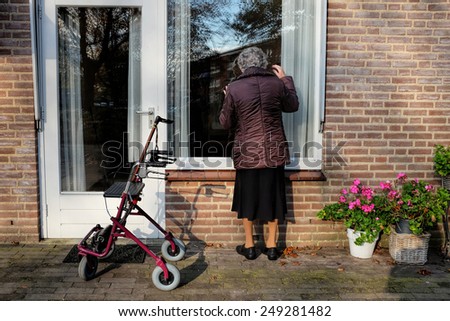 Elderly lady with walker is visiting a friend in a care home