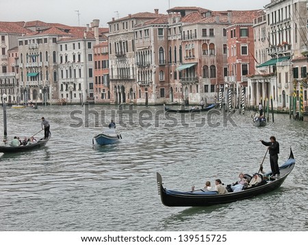 VENICE - MAY 17: Gondoliers navigate on the Venice canals morning on May 17, 2009 in Venice, Italy. The gondola is a traditional, flat-bottomed Venetian rowing boat.