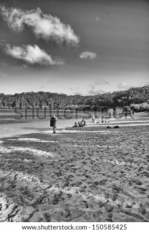 FRASER ISLAND, AUSTRALIA - JUL 11: Tourists enjoy Lake MacKenzie on a winter afternoon, July 11, 2010 in Fraser Island, Australia. The island is considered to be the largest sand island in the world.