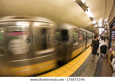 NEW YORK CITY - MAY 23, 2013: Train speeds up in a subway station of New York. Owned by the NY City Transit Authority, the subway has 469 stations in operation.