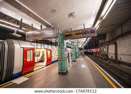 LONDON - SEP 15, 2013: Train ready to depart in the underground station. London underground serves more than 3 million people every day.