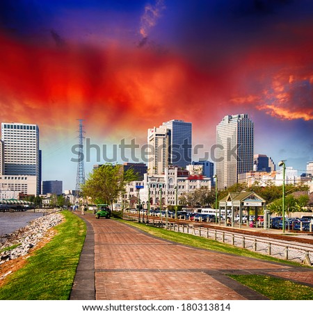New Orleans at sunset. Spectacular view of riverwalk with city buildings.