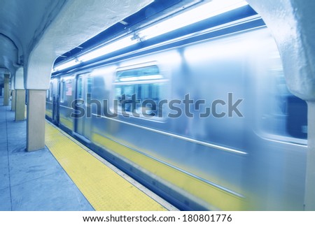 Train speeding up in New York City subway station. Vintage filter