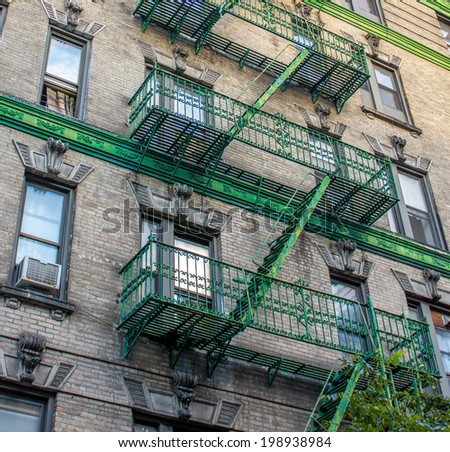 Building with green ladders for fire escape, Mott Street New York.