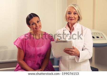 Expert female doctor showing medical exams to happy woman in 40s.