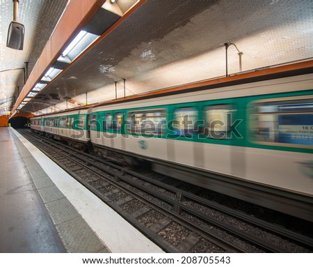 Paris subway station with speeding train blur, France.