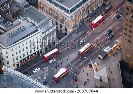 LONDON - SEP 9, 2013: Classic Red Double Decker Buses on the city streets, aerial view. An icon of the city,these modern buses came to replace an old classic,the AEC Routemaster.