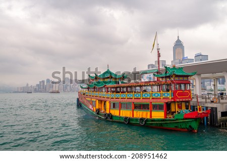 Hong Kong port. Colourful old cruise ship with city skyline on background.