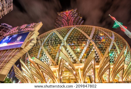 MACAU - APRIL 21, 2014: Lights of City Casinos on a cloudy night. Gambling in Macau has been legal since the 1850s when the Portuguese government legalised the activity in the colony.