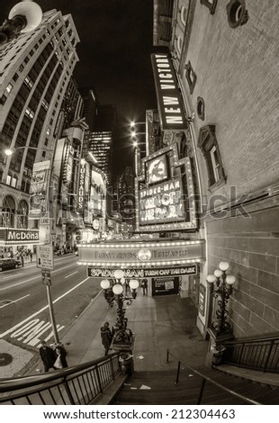 NEW YORK CITY - FEBRUARY 11, 2012: Tourists walk along Midtown at night. More than 50 million people visit the city every year.