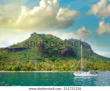 Wonderful dream island in Polynesia with small boat and Ocean.