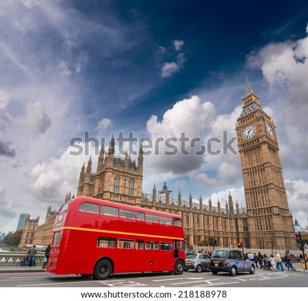 Red bus on Westminster Bridge under a dramatic sky - London.