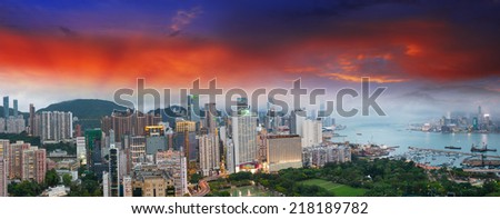 Sunset sky over Hong Kong bay. Aerial view of city skyscrapers.